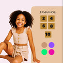 menina mostrando os tamanhos da tebala de medidas com conjunto infantil alfaiataria 