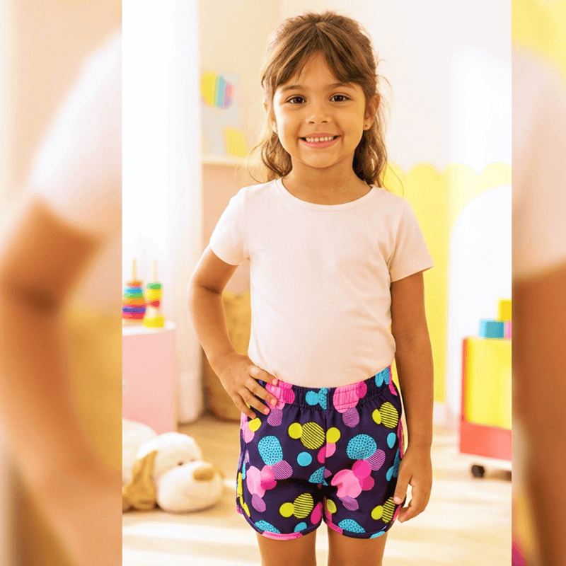 short tactel infantil azul marinho com estampa de bolas e círculos neon coloridos